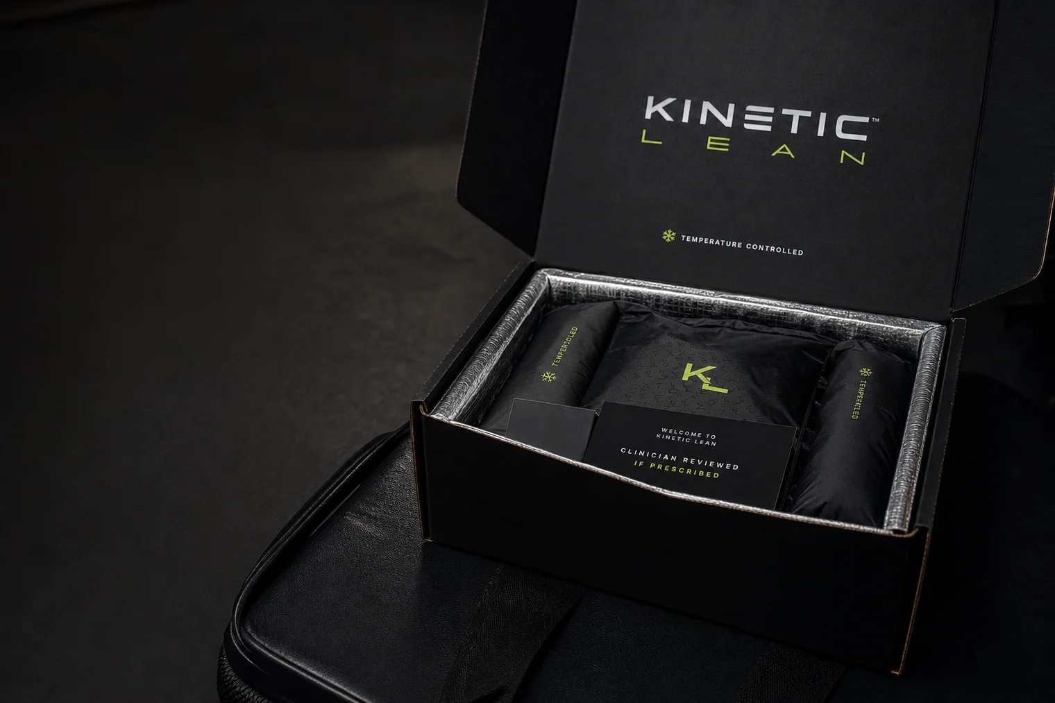 Opened matte black Kinetic Lean cold-chain delivery box with insulated packaging